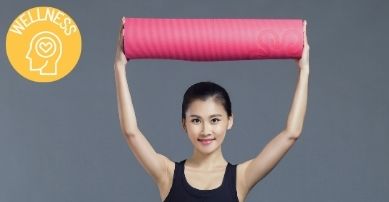 girl holding yoga mat