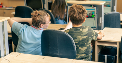 Tech camp staff teaching a child at the computer