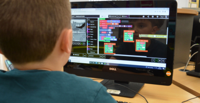 Boy doing coding on a computer