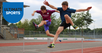 Boy jumping a hurdle