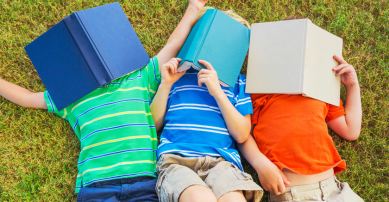Three boys with books over their faces!
