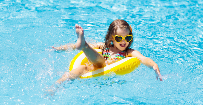 Girl in a yellow ring in a swimming pool