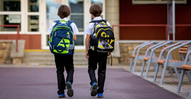 Two boys walking into school