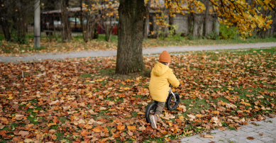 boy riding a bike in autumn