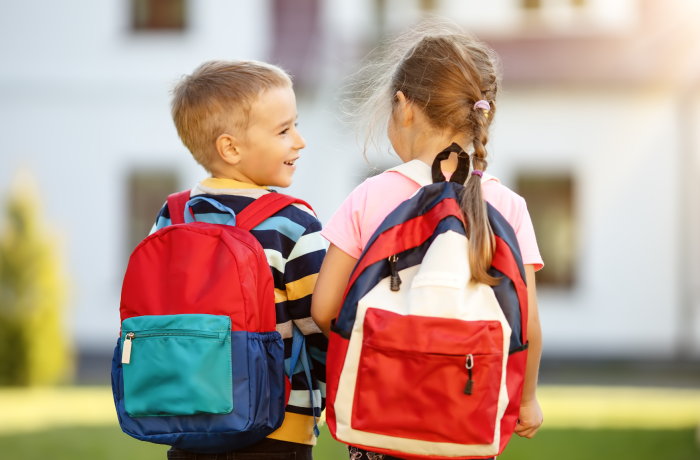Boy and girl with backpacks on