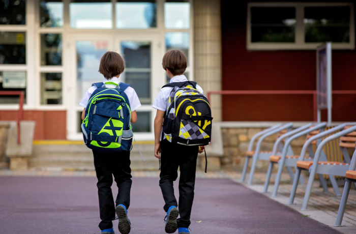 Two boys walking into school