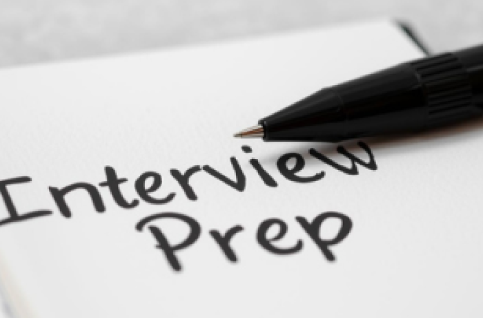 A note book saying Interview prep with pen 