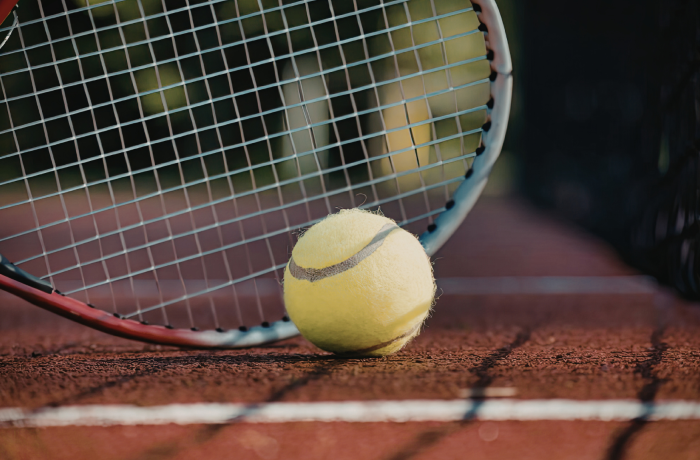 Tennis ball, court and racket