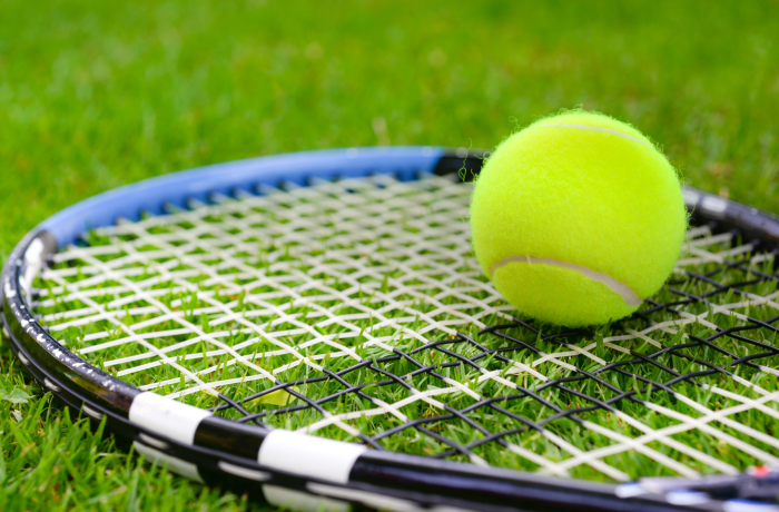 Tennis ball, court and racket