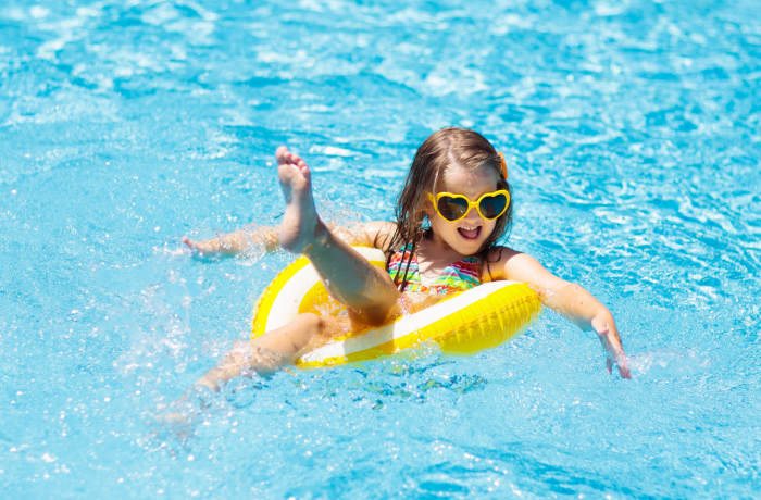 Girl in a yellow ring in the swimming pool