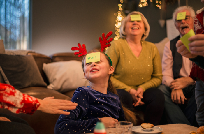 Family playing guess who at christmas