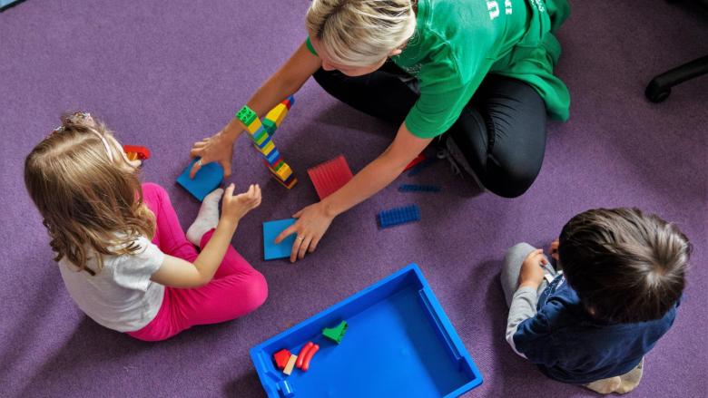 Staff with child building blocks