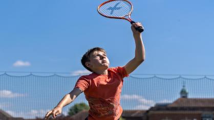 boy playing tennis