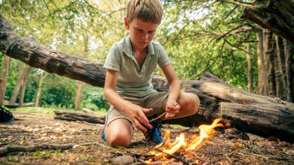Boy lighting a fire
