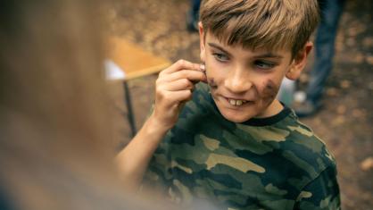 Boy applying face paint